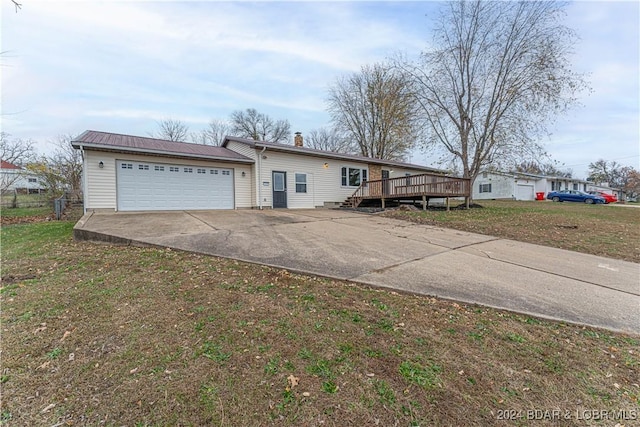 view of front of home featuring a wooden deck and a garage