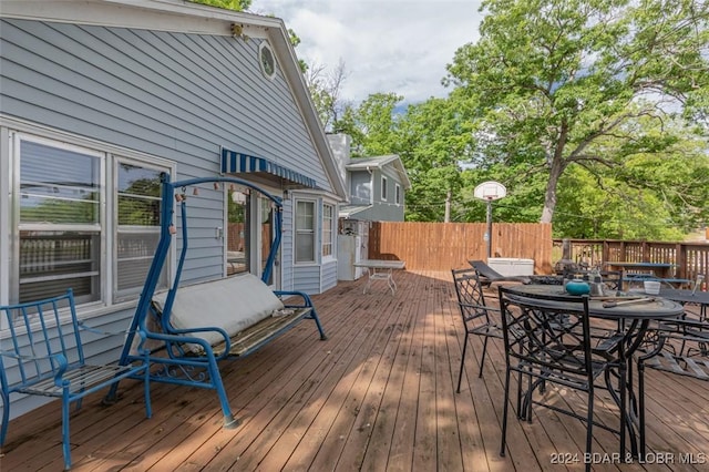 wooden terrace featuring fence and outdoor dining area