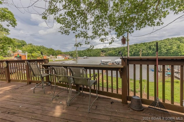 wooden deck featuring a lawn