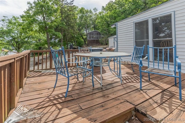 wooden deck featuring outdoor dining space