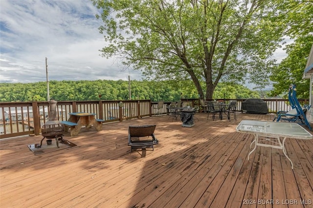 wooden terrace featuring outdoor dining space