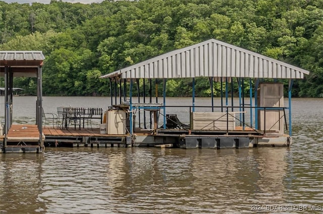 view of dock featuring a water view and a view of trees