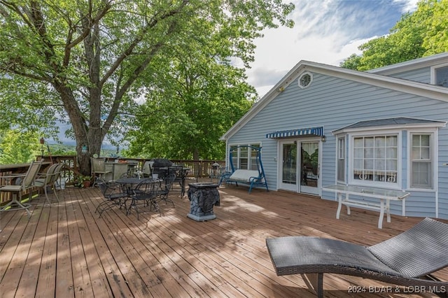 wooden deck with outdoor dining space