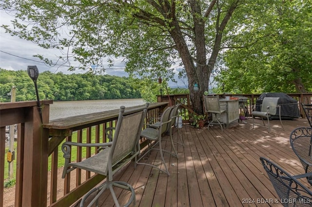 deck featuring grilling area and a water view