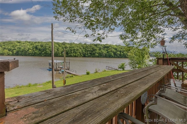 dock area with a water view and a wooded view