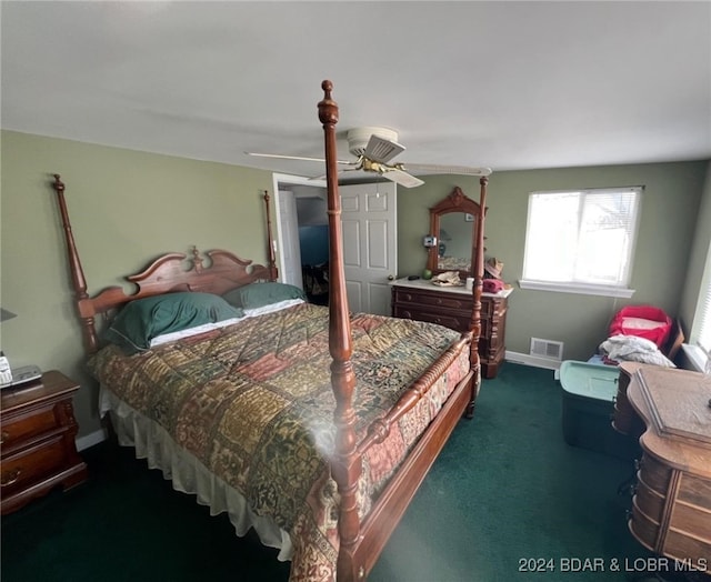 bedroom with a ceiling fan, dark colored carpet, visible vents, and baseboards