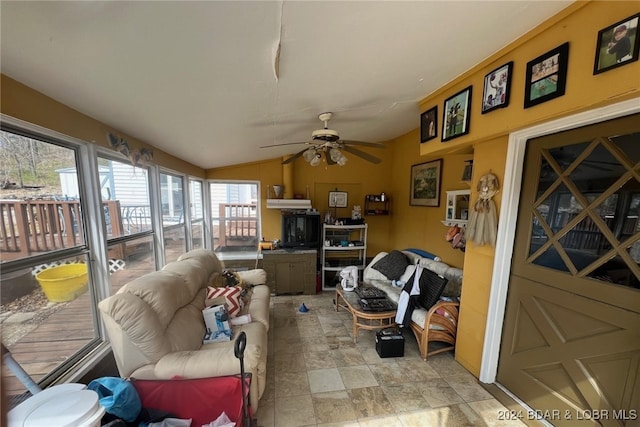 interior space with a ceiling fan and vaulted ceiling