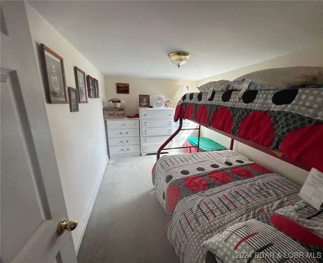 carpeted bedroom featuring baseboards