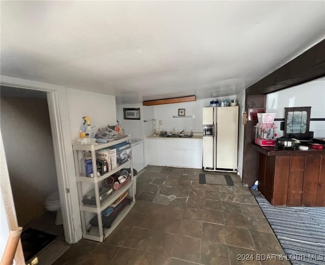 kitchen with white refrigerator with ice dispenser