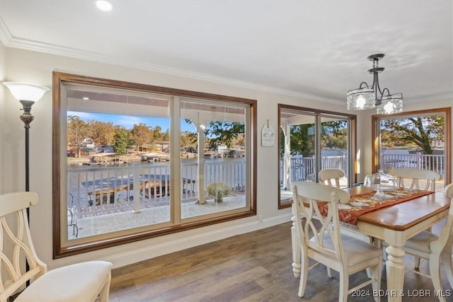 sunroom / solarium featuring a water view and a notable chandelier