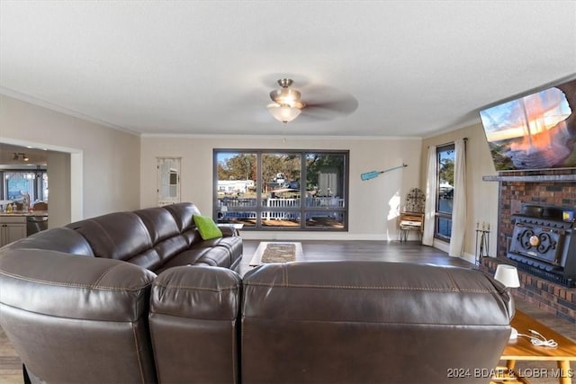 living room with hardwood / wood-style flooring, ceiling fan, and crown molding