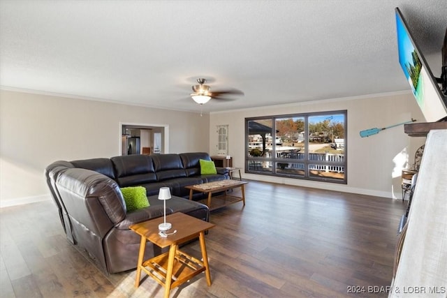 living room featuring a textured ceiling, dark hardwood / wood-style floors, ceiling fan, and crown molding