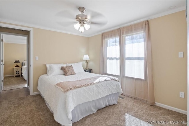 bedroom with carpet, ceiling fan, and crown molding