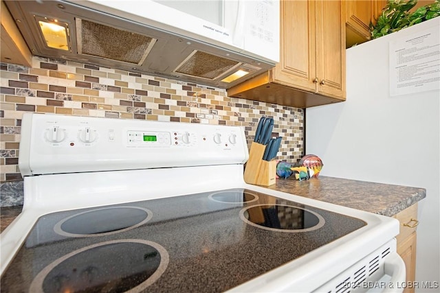 kitchen featuring tasteful backsplash and white appliances