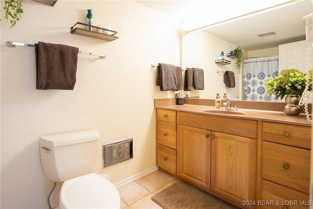 bathroom featuring toilet, a shower with curtain, vanity, and tile patterned floors