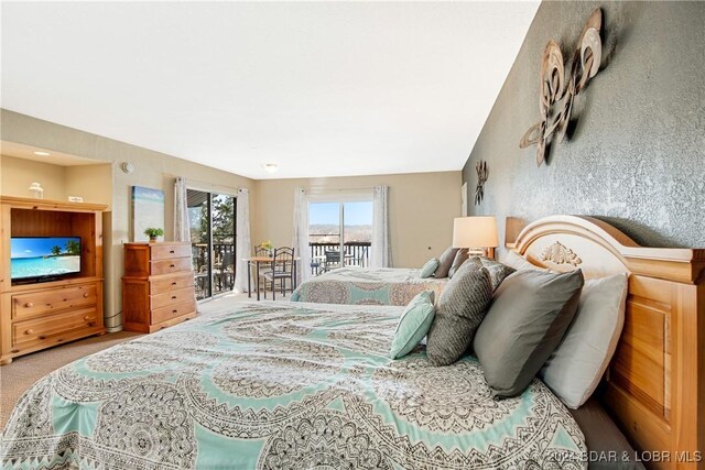 bedroom featuring carpet flooring and access to exterior