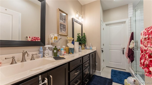 bathroom with tile patterned floors, vanity, and a shower with door