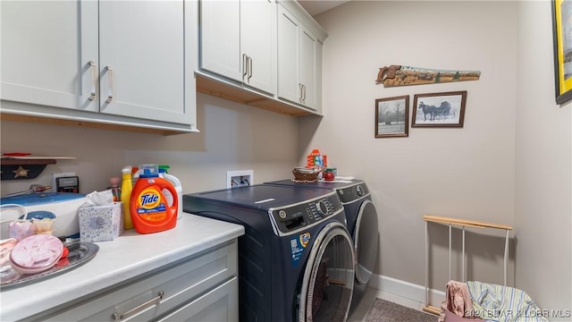 laundry room featuring cabinets and separate washer and dryer