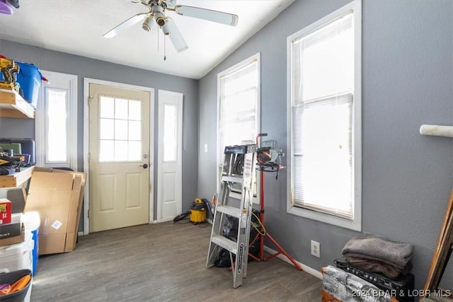 interior space with hardwood / wood-style flooring, ceiling fan, and vaulted ceiling