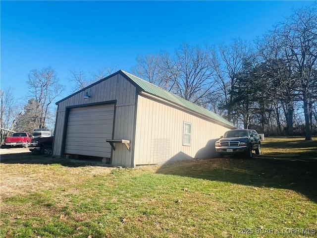 view of outbuilding with a garage and a lawn