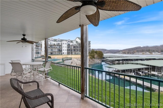 balcony featuring a water and mountain view