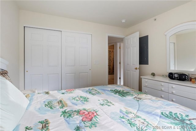 bedroom featuring electric panel and a closet