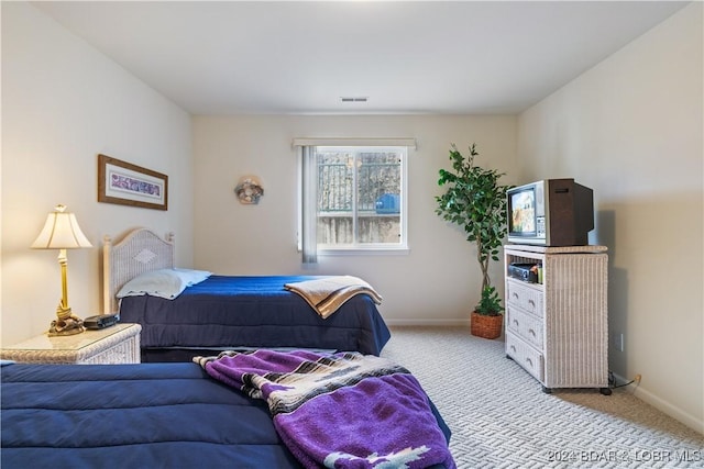 bedroom featuring light colored carpet