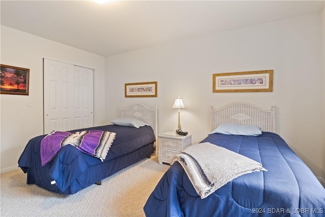 carpeted bedroom featuring a closet