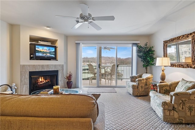 living room with carpet flooring and a tiled fireplace