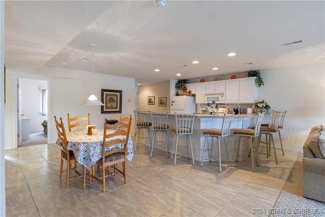 dining space featuring light tile patterned floors