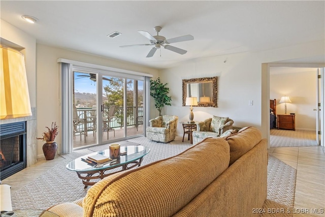 tiled living room featuring ceiling fan