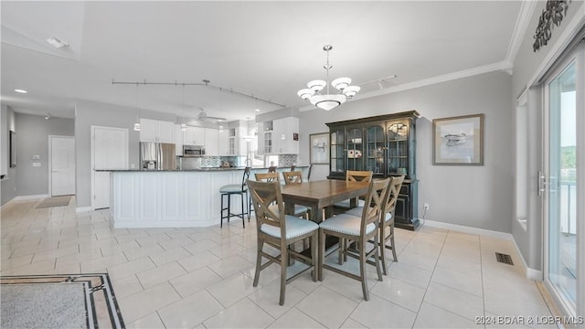 dining room featuring ornamental molding, light tile patterned floors, and a chandelier