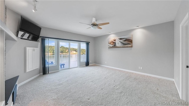 carpeted spare room with ceiling fan