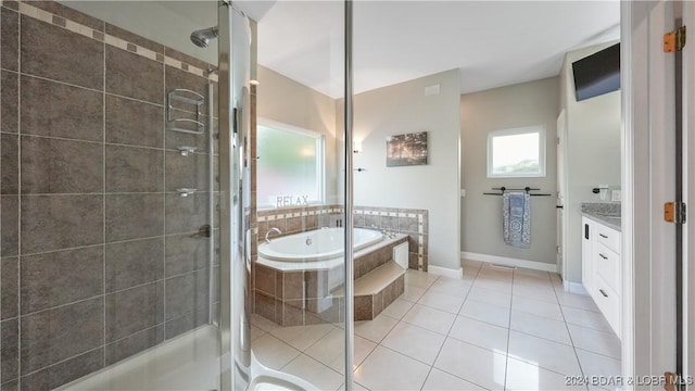 bathroom with tile patterned flooring, vanity, and independent shower and bath