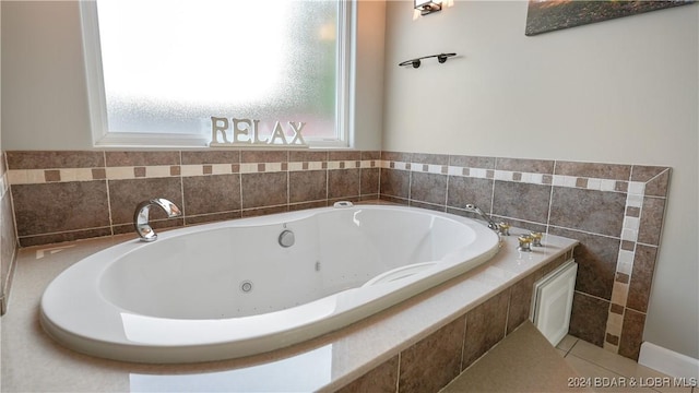 bathroom with plenty of natural light and a relaxing tiled tub