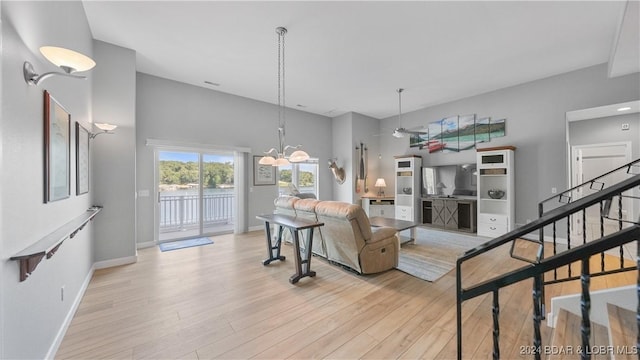 living room with a chandelier and light hardwood / wood-style flooring