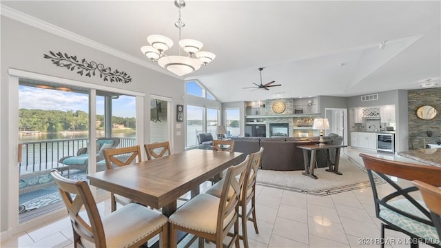 tiled dining space with a water view, a healthy amount of sunlight, vaulted ceiling, and beverage cooler