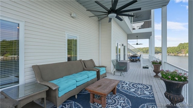 deck with an outdoor hangout area, a water view, and ceiling fan