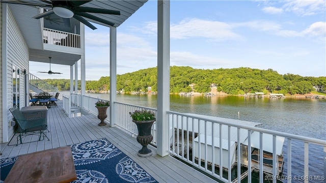 exterior space with ceiling fan and a water view