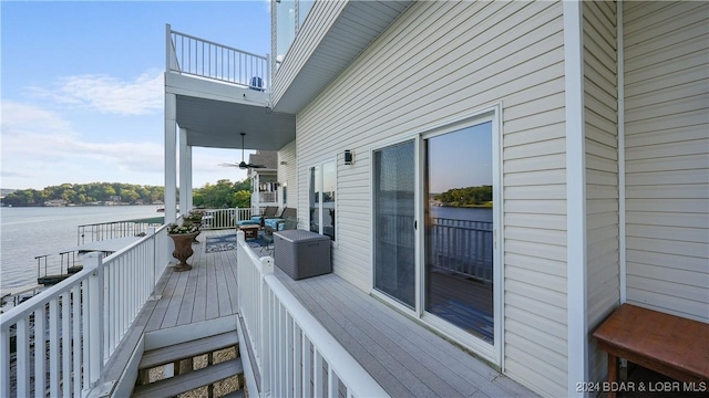 wooden deck featuring a water view and ceiling fan