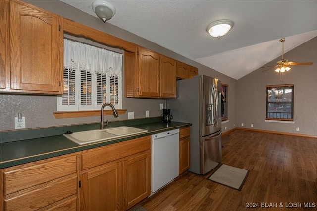 kitchen featuring dishwasher, dark hardwood / wood-style flooring, sink, and vaulted ceiling