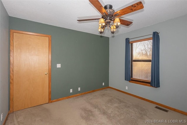 carpeted empty room with ceiling fan