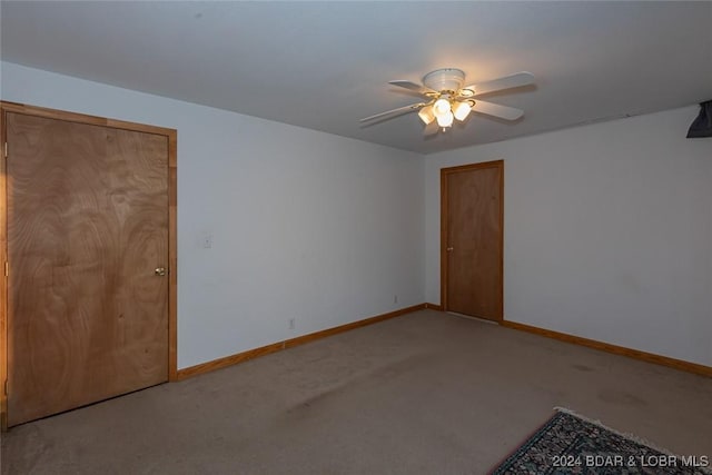 carpeted empty room with ceiling fan