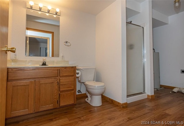 bathroom with hardwood / wood-style floors, vanity, an enclosed shower, and toilet