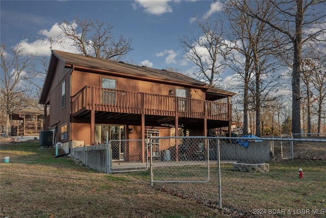 back of house with a wooden deck and central AC unit