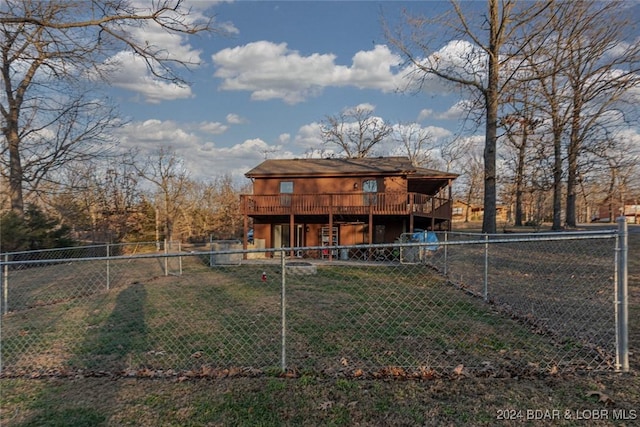 rear view of house with a yard and a deck