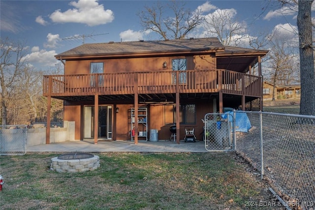 back of property featuring a fire pit, a patio area, and a wooden deck