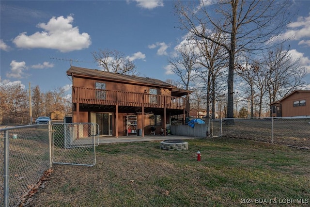 rear view of house with a patio area, a deck, and a yard