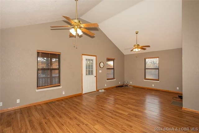 unfurnished living room featuring light hardwood / wood-style floors, high vaulted ceiling, and ceiling fan