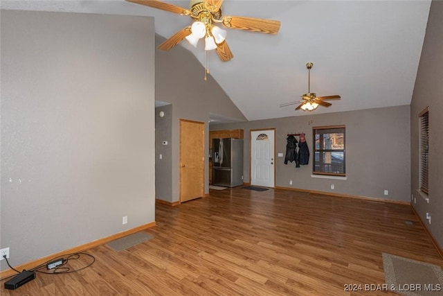 unfurnished living room featuring light hardwood / wood-style floors, high vaulted ceiling, and ceiling fan